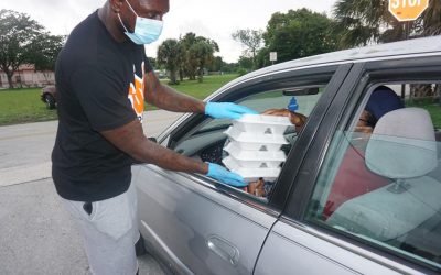 man handing out food