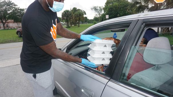 man handing out food